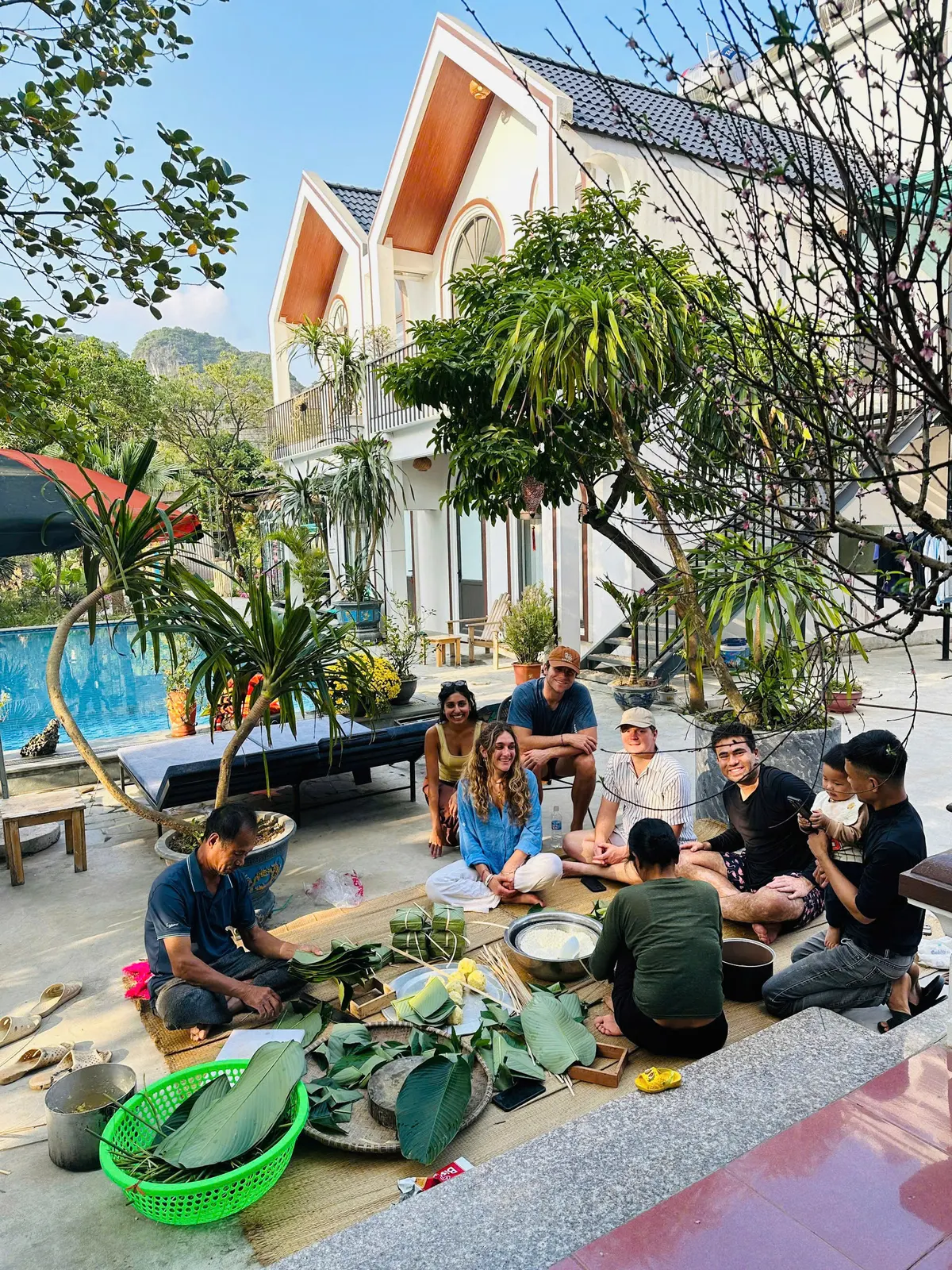 A group preparing food together beside the pool